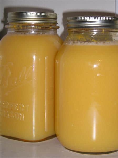 two jars of canned orange juice