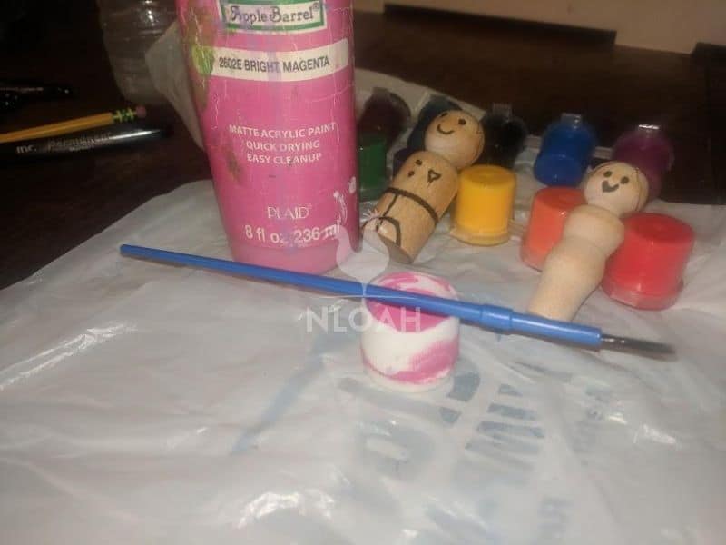 painting the peg dolls' faces