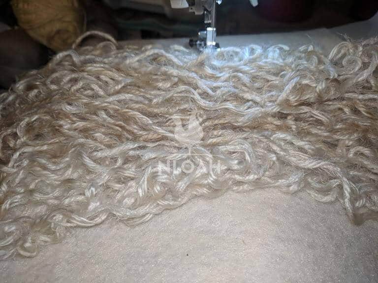 scalp with yarn on sewing machine