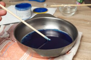 mixing blue mica powder with melted candle wax