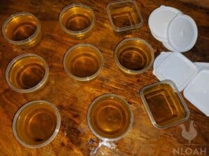 adding salve to the plastic cups