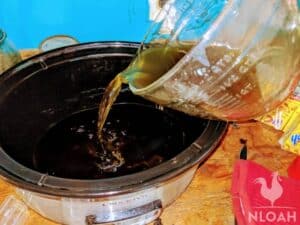 pouring liquid into slow cooker