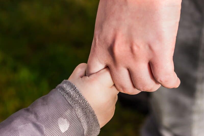 child holding adult hands