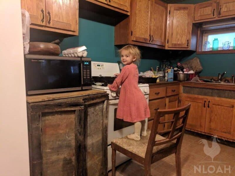 little girl cooking on the stove
