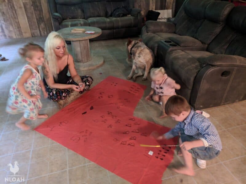 kids playing a science game with homeschooling mom