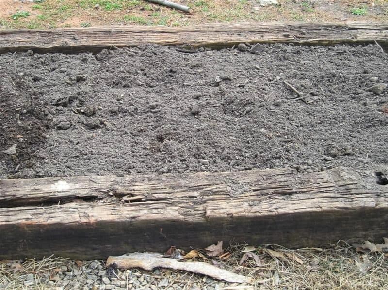 adding compost to raised bed