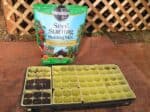 seed starting trays next to bag of seed starting potting soil mix