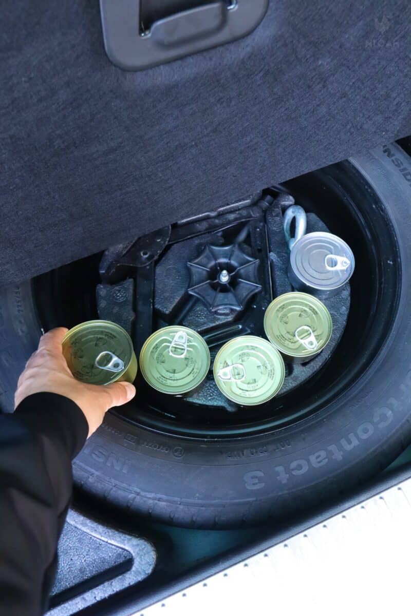 stashing cans of food inside car trunk