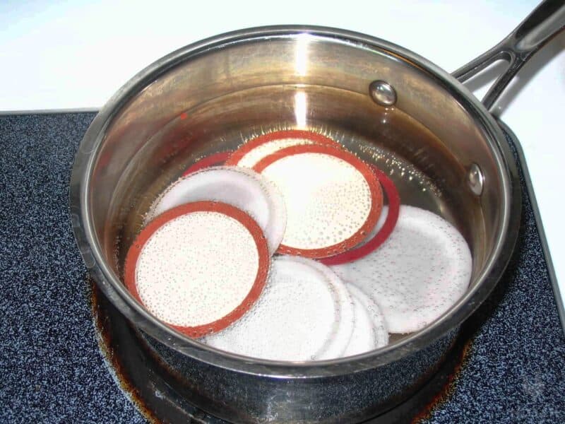 boiling canning lids in pot of water
