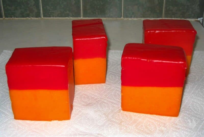 top halves of pieces of cheese covered in wax