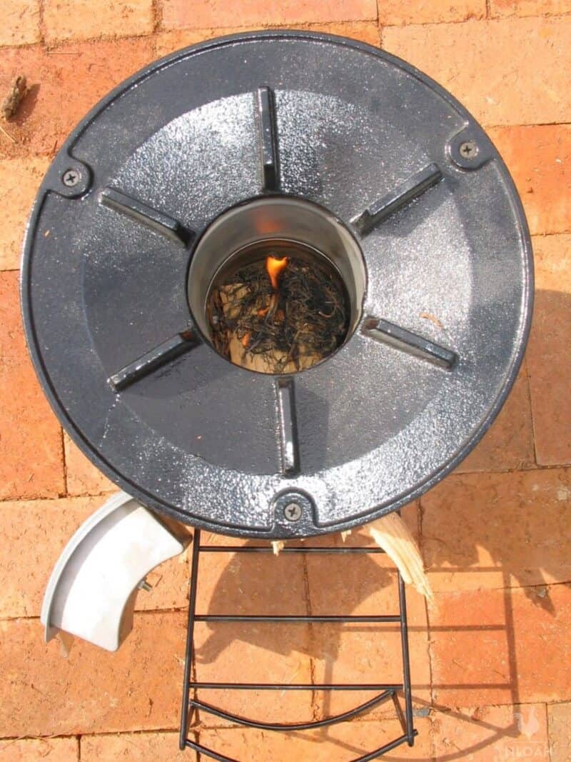 rocket stove with fire inside just lit