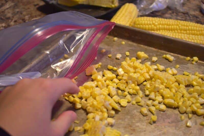 adding corn to freezer bag