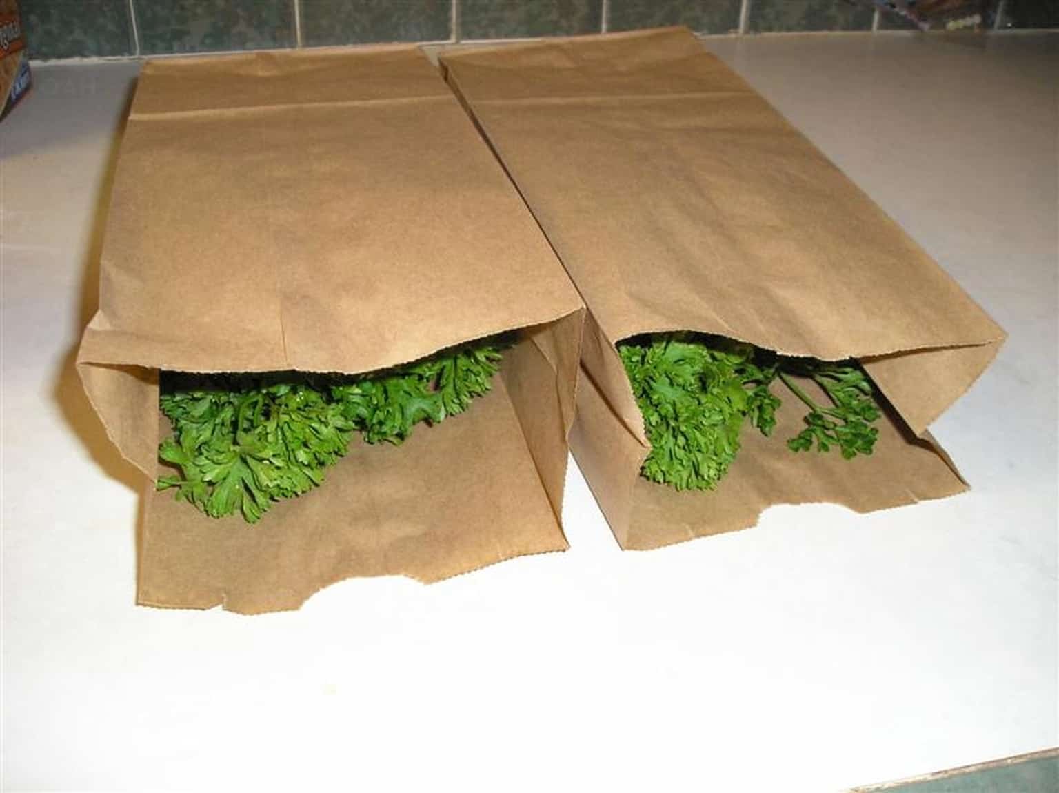 parsley inside two brown paper bags
