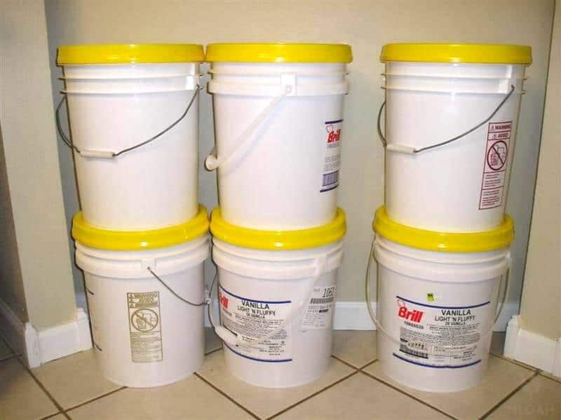 6 plastic buckets filled with wheat berries