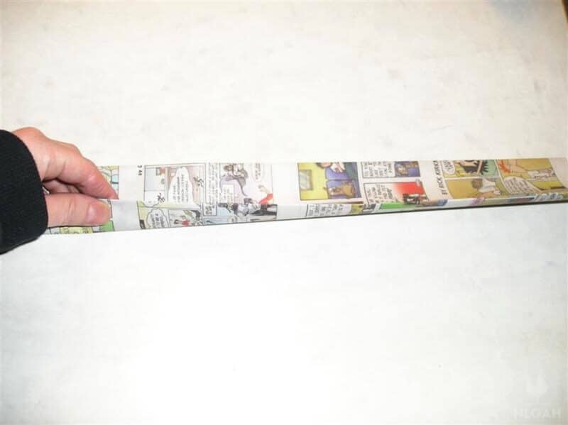 folding newspaper strip lengthwise