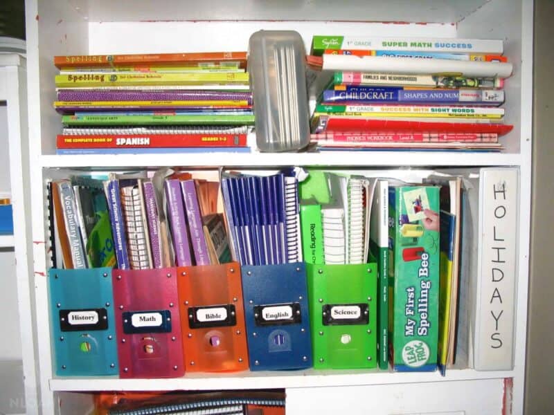 shelves with homeschooling books and notebooks