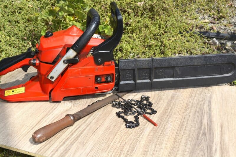 chainsaw next to sharpening tools