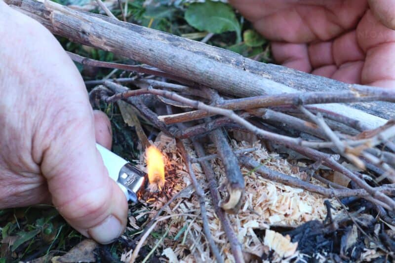 starting a fire with a lighter and sawdust