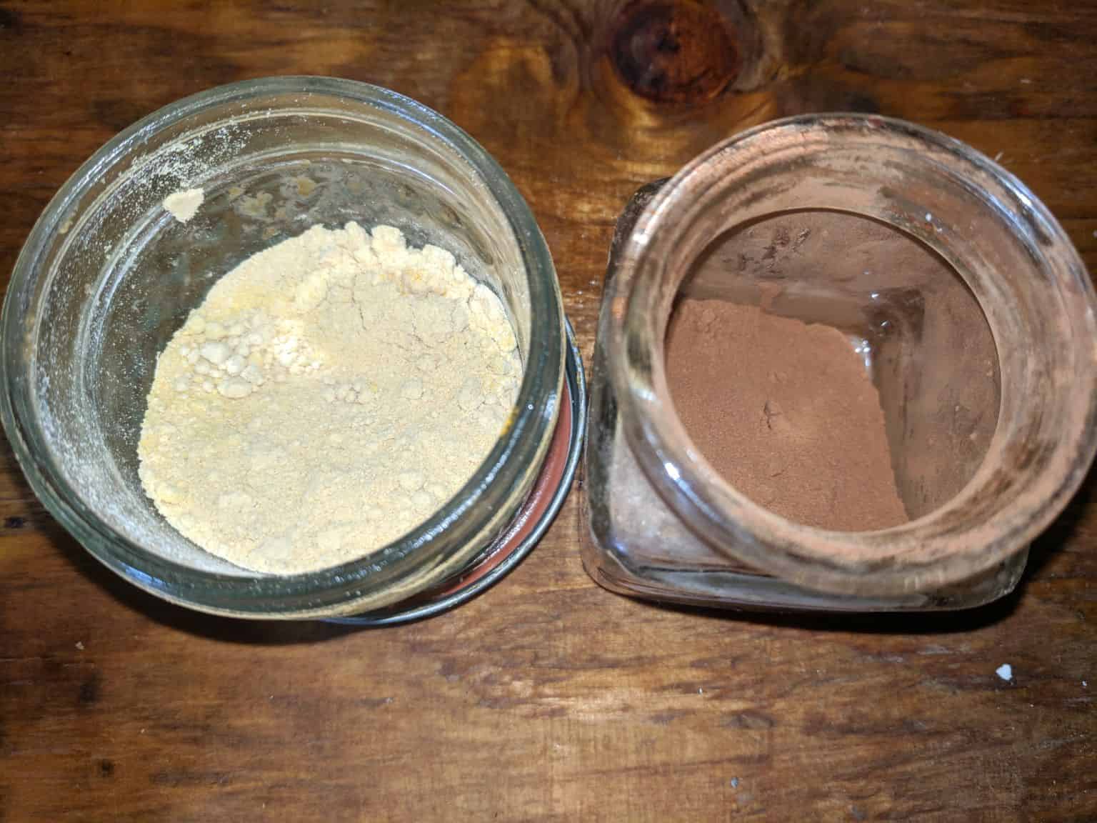 two shades of homemade eye shadow in glass jars