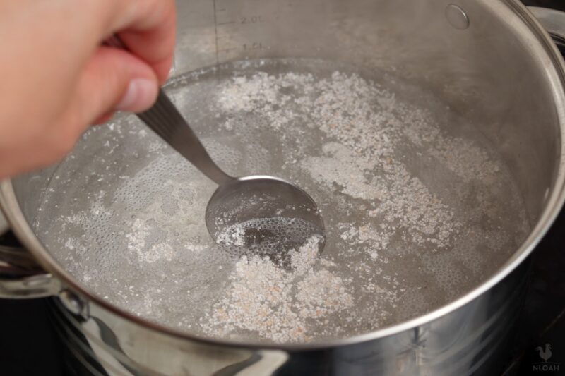 stirring eggshells in the pot