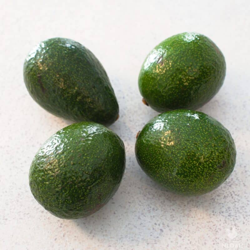 four avocados on kitchen counter