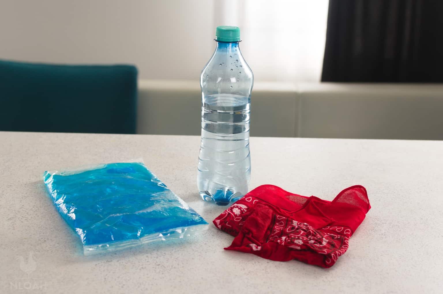 bottle of water next to ice pack and wet shemagh