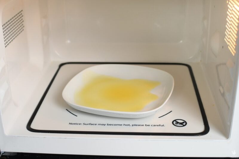 decrystallized honey on plate inside microwave