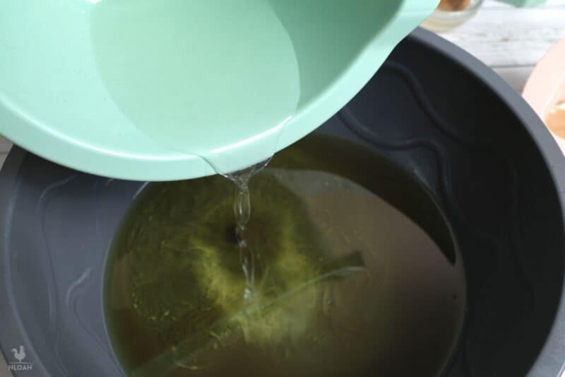 pouring lye solution over heated oil