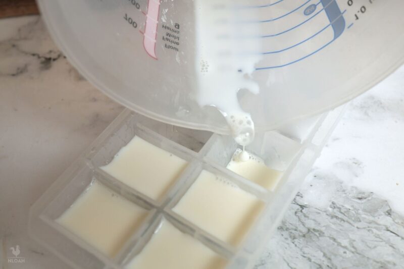 pouring goat milk in ice cube trays