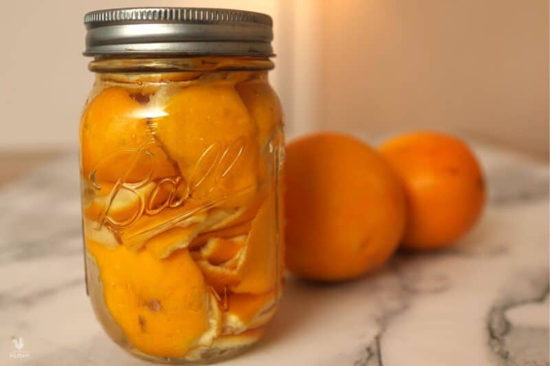 orange zest with vinegar in glass jar