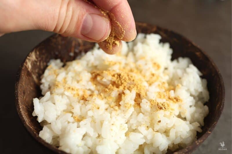 sprinkling powdered orange over rice