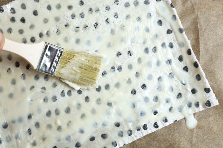brushing beeswax onto fabric