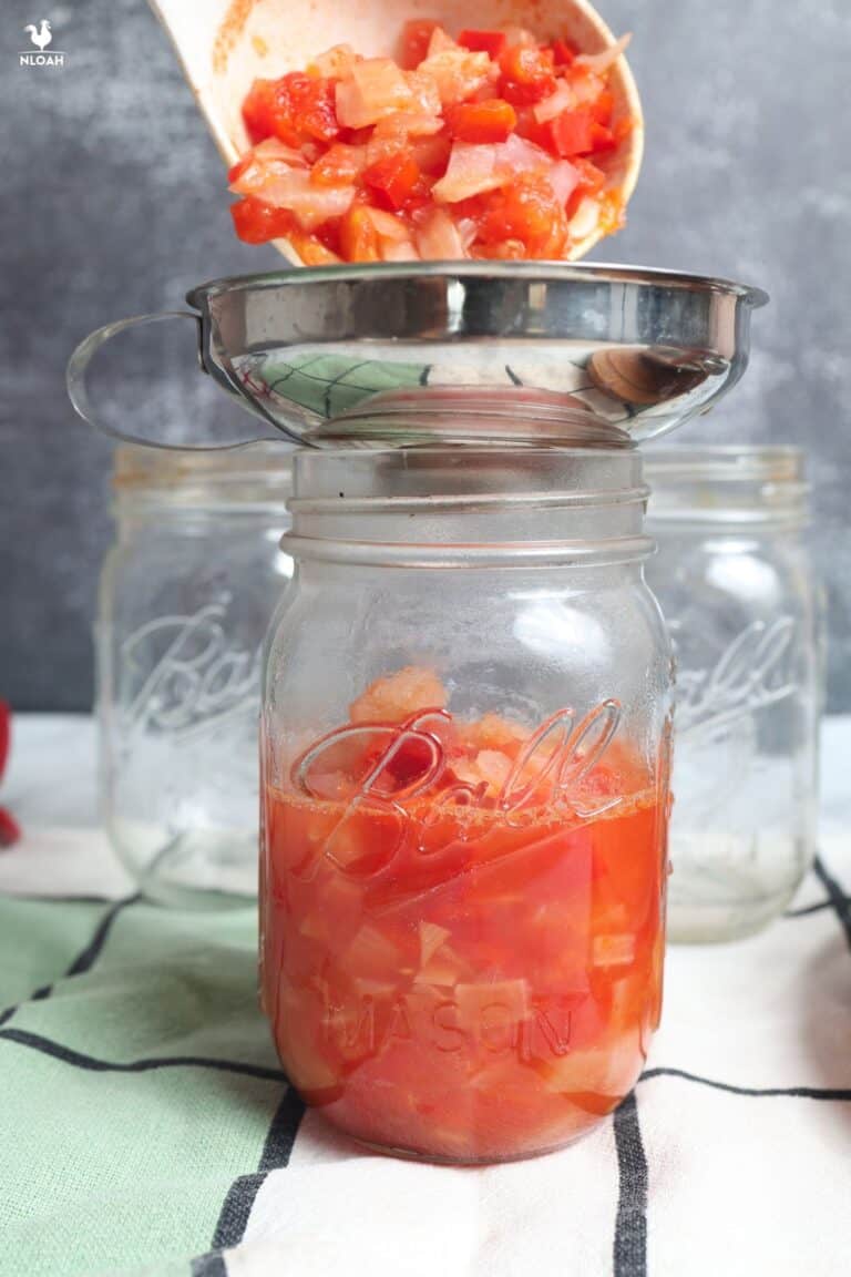 ladling salsa into canning jars